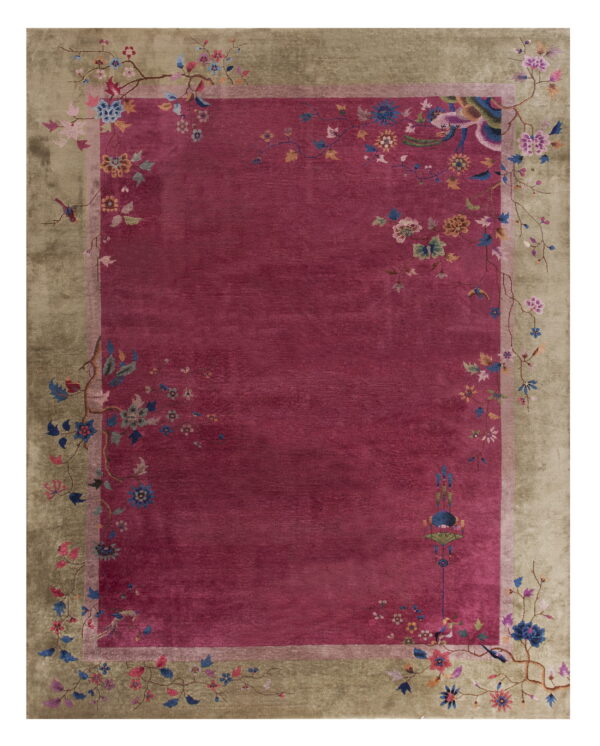 Plush magenta rug with a wide khaki border patterned with stylized vines and colorful flowers.