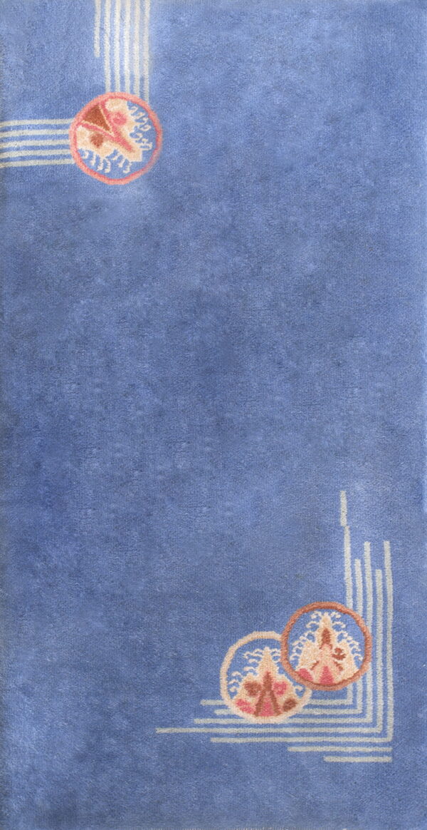 Periwinkle blue rug with white geometric lines and circular pink, tan, and cream decorative corner motifs.