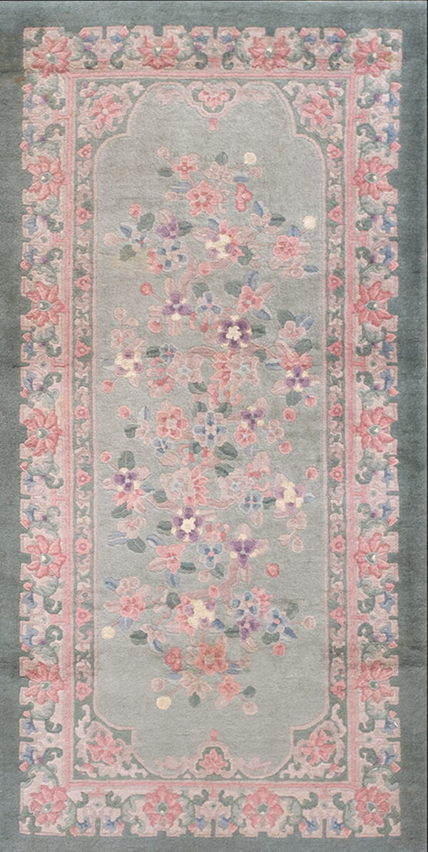 Pale sage runner rug with a central arch field decorated with pink and purple floral blossoms.