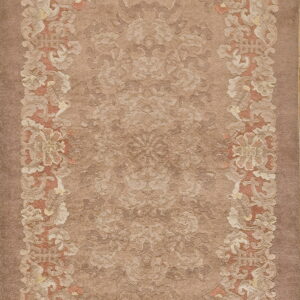 Low-pile rug in brown and tan with a sculpted botanical border and subtle floral field pattern.