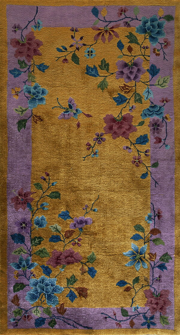 Golden yellow high pile rug featuring a dense blue and purple floral pattern inside a lavender border.