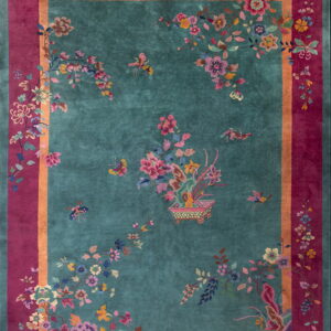High-pile rug featuring a turquoise field, magenta border, and multicolored blossoms and butterflies.