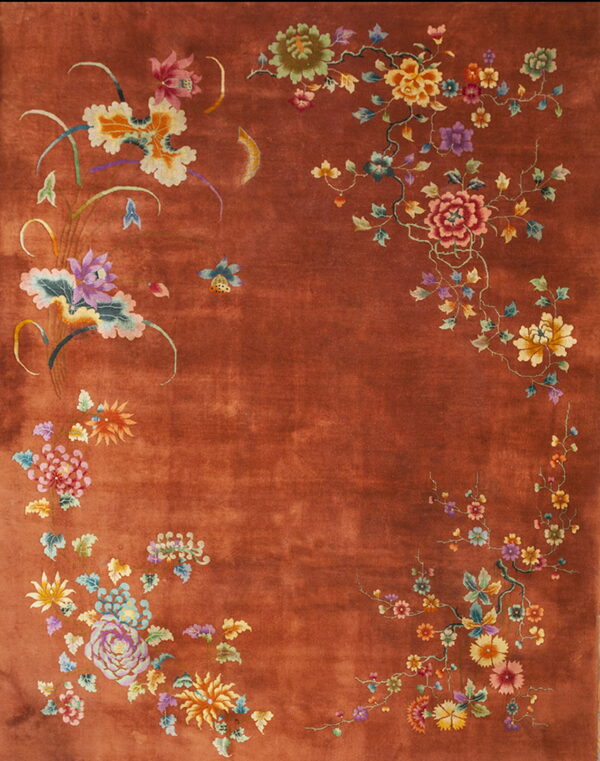 Terracotta rug featuring detailed multicolor flowers and vines clustered around the edges of the central field.