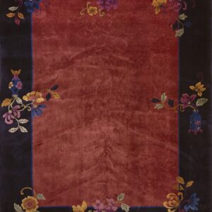 Deep red-orange rug with a dark border featuring multicolored floral and vine motifs at the corners.