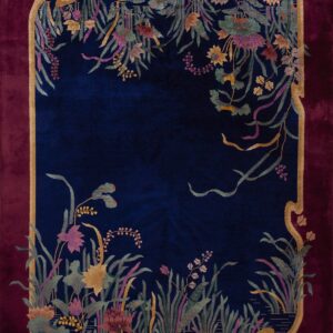 Plush navy rug with a burgundy border, intricately patterned with stylized reeds, leaves, and flowers.