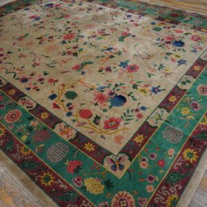 Multicolor floral rug with an ivory field and wide teal-green border lies on aged wooden planks.