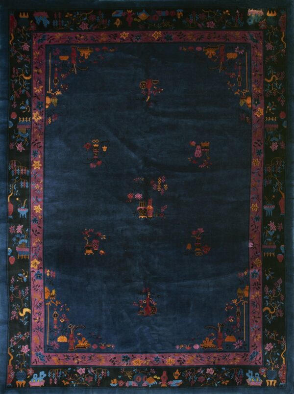 Deep blue rug with scattered vase motifs and elaborate black borders featuring colorful flowers and birds.