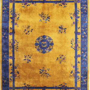 Traditional gold rug with a deep blue border, featuring scattered florals and a central medallion.