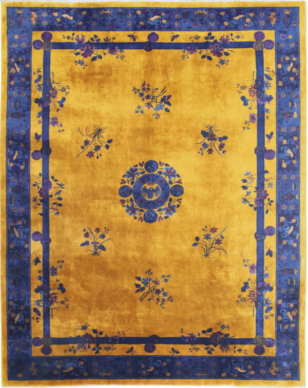 Traditional gold rug with a deep blue border, featuring scattered florals and a central medallion.