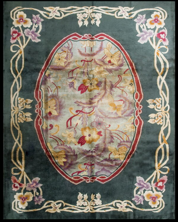 Teal rug with a large floral oval medallion and stylized multicolored vine borders.