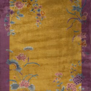 Gold plush rug with a wide purple border and colorful floral vine details.