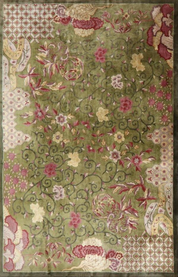 Vibrant lime green rug featuring an all-over design of scrolling vines, red flowers, and patterned corner panels.