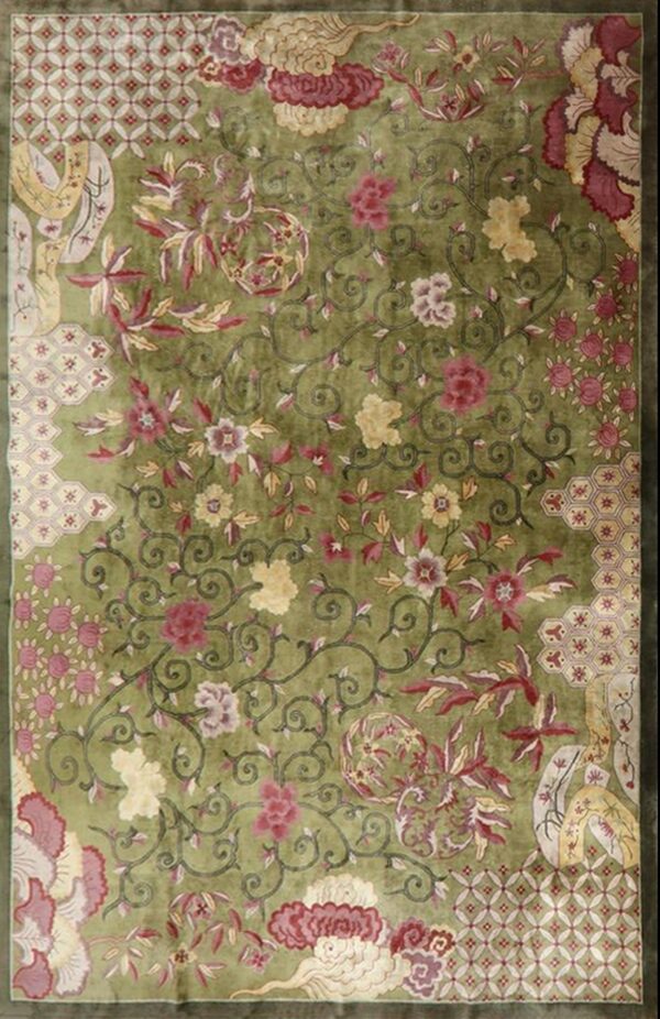 Vibrant lime green rug featuring an all-over design of scrolling vines, red flowers, and patterned corner panels.