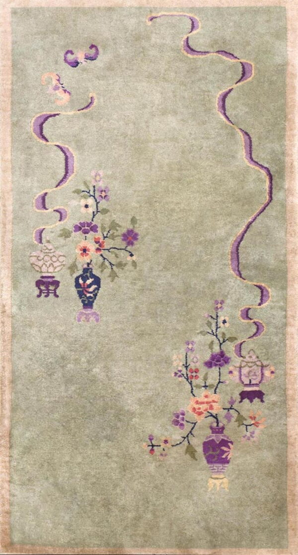 A sage green runner rug features floral vases and lanterns accented by a curving purple ribbon design.