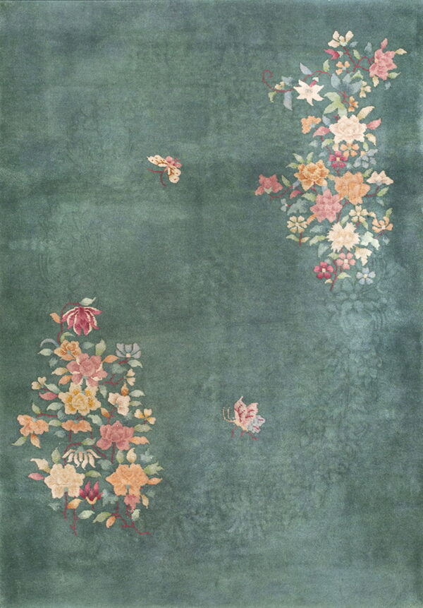 A dusty teal rug featuring large asymmetrical floral groupings in pink, orange, and cream colors.