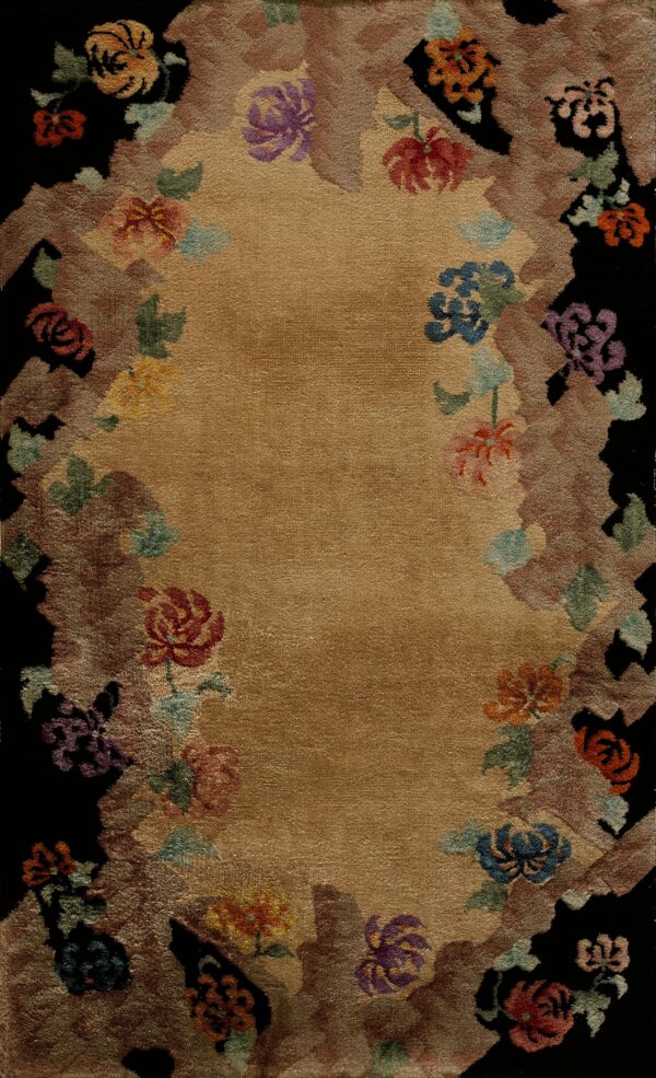 Tan medium-pile rug featuring a border of multicolored florals and earth tones outlining a black edge.