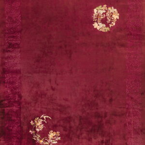 Plush maroon rug with a darker tonal border and multi-colored cream and green floral accents on the field.