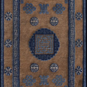 Brown rug with a central blue geometric medallion, scattered blue motifs, and fretwork border design.