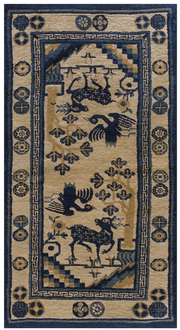 Low-pile tan rug featuring dark blue birds, trees, and deer motifs with elaborate borders.