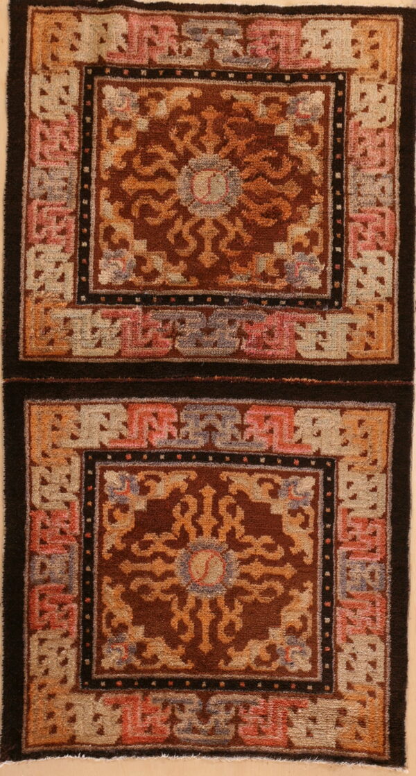 Brown, orange, and beige rug with geometric borders and two stacked panels of dense pile.