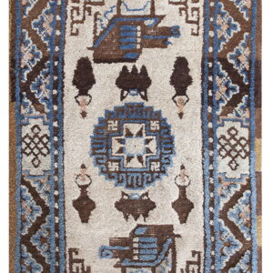 Geometric brown, blue, and white rug featuring stylized figures and detailed borders with a visible medium pile texture.