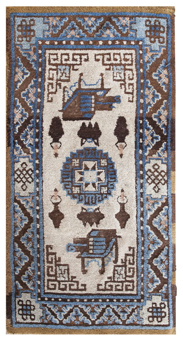 Geometric brown, blue, and white rug featuring stylized figures and detailed borders with a visible medium pile texture.
