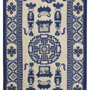 Beige runner rug with dense navy blue geometric borders and stylized, symmetrical central motifs.