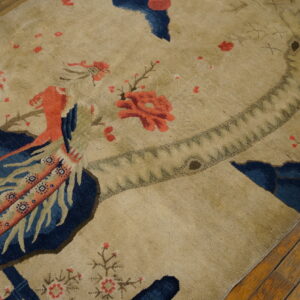 High-pile tan rug with a detailed pictorial scene featuring a large red bird and blue areas.