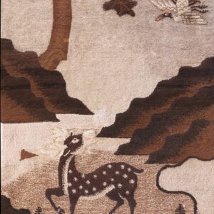 Sculpted pile rug in brown and taupe with a forest scene featuring a deer, tree, and bird.