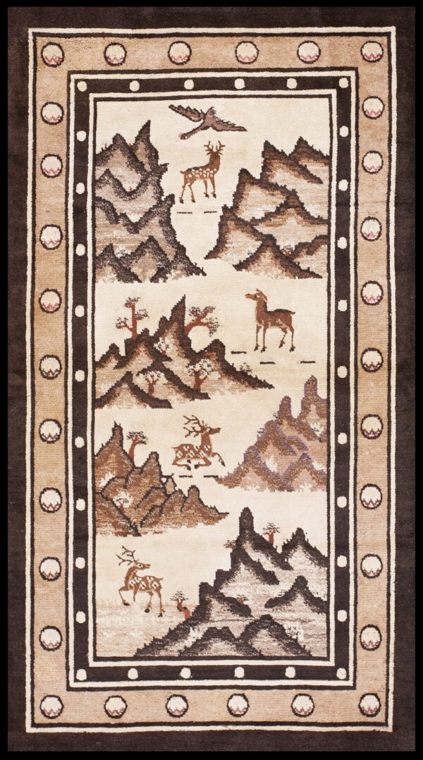 Ivory and brown pictorial rug depicting deer, a bird, and mountains, surrounded by a complex geometric border.