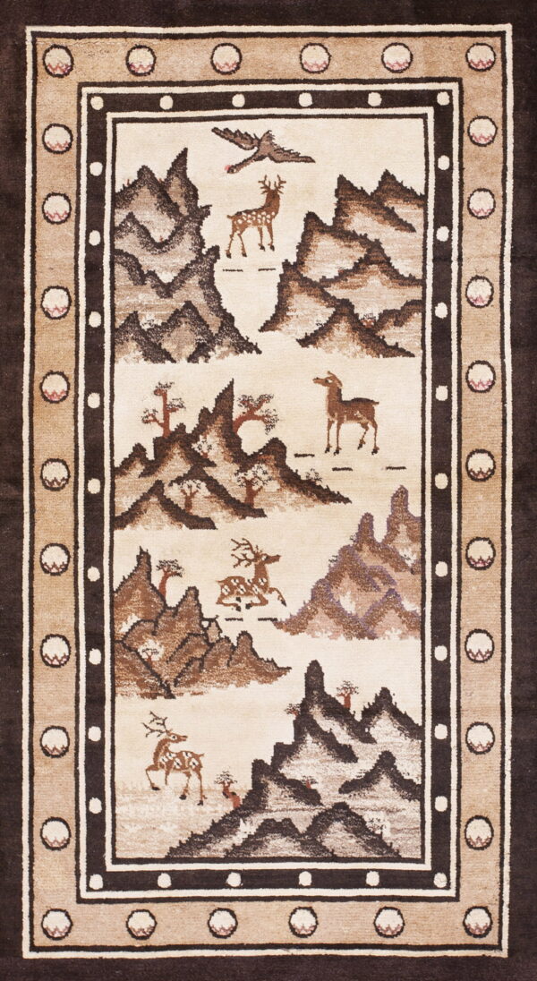 Beige and dark brown rug showing a scenic landscape of stylized mountains, deer, and trees.