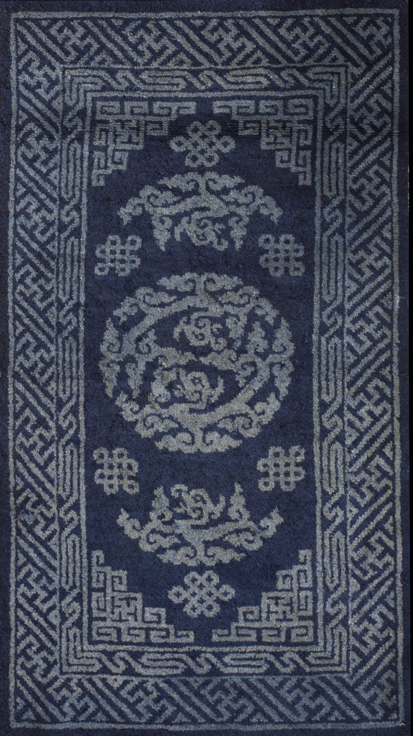 Rectangular navy rug with medium pile, featuring intricate gray-blue geometric borders and cloud designs.
