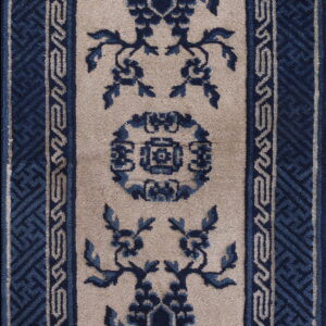 Traditional runner rug in blue and beige featuring a central medallion and ornate key pattern borders.