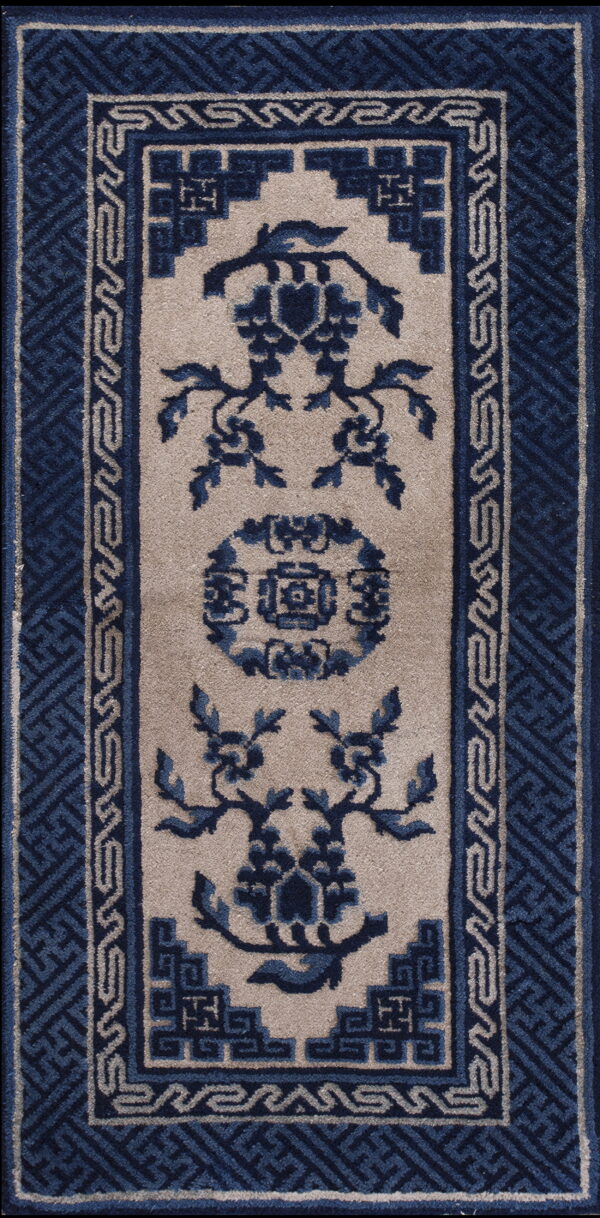 Traditional runner rug in blue and beige featuring a central medallion and ornate key pattern borders.
