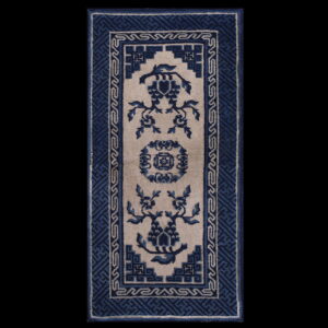 Narrow blue and beige runner rug with a central floral design and thick geometric borders.