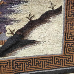 High-pile rug featuring a cream landscape with purple and black elements, framed by a rust geometric border.