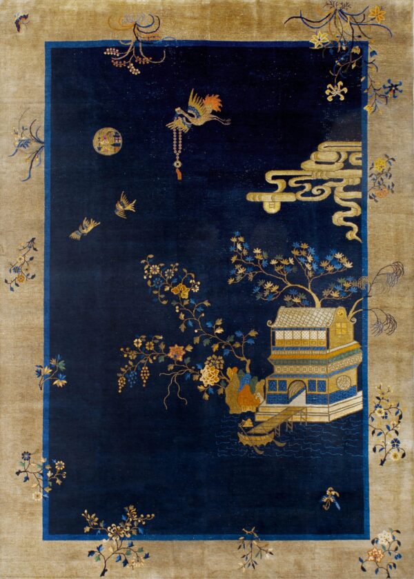 Navy blue rug with a taupe border and intricate scenes of buildings, stylized clouds, and birds on wood flooring.