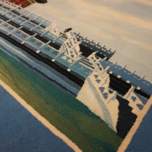 Pictorial low-pile rug featuring a large ship design rendered in blues, white, teal, and green colors.
