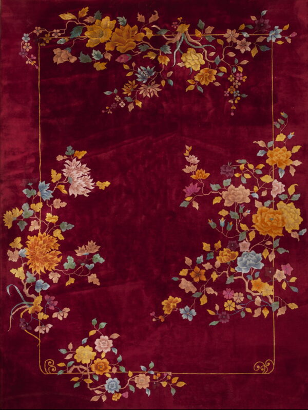 A velvety deep red rug featuring abundant multicolor floral arrangements framing the center panel.