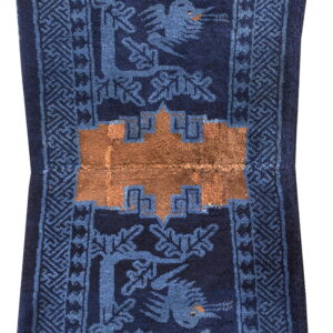 Dark blue runner rug featuring medium blue deer, birds, and trees with a central copper geometric design.