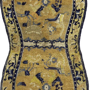 Hourglass-shaped rug with a gold center, blue and yellow floral motifs, and a dark blue curved border.
