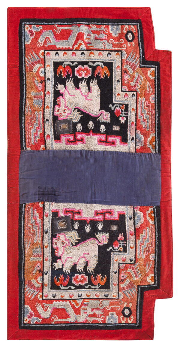 Red, black, and orange textile with complex mythical animal patterns divided by a wide indigo band.
