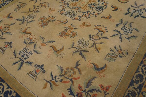 Beige rug featuring a detailed traditional pattern of navy, rust, and teal floral elements and a scrolled border.