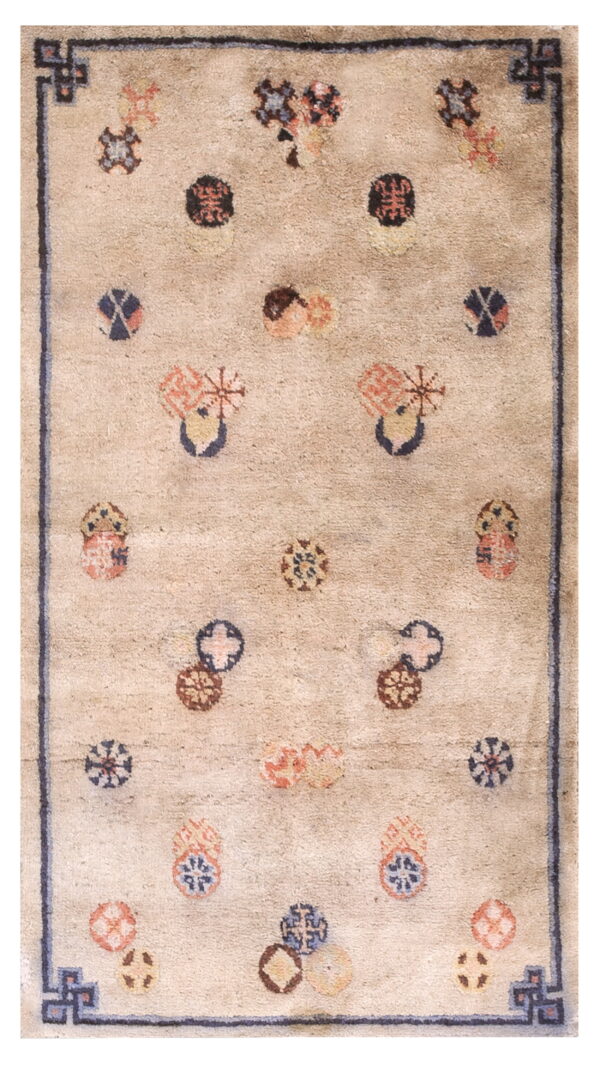 Low-pile beige rug featuring a dark blue border and scattered abstract motifs in coral, navy, and brown.