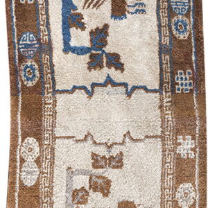 Shaggy cream and brown runner rug featuring blue accents and stylized animal and geometric patterns.