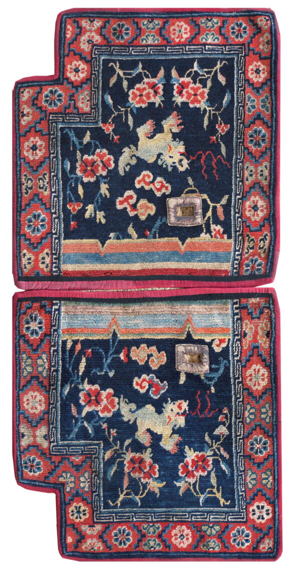 A pair of stacked navy mats featuring red floral patterns, mythological animals, and geometric red borders.