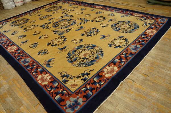 Yellow rug featuring scattered blue cloud and floral motifs, bordered by navy and rust red bands on wood floors.