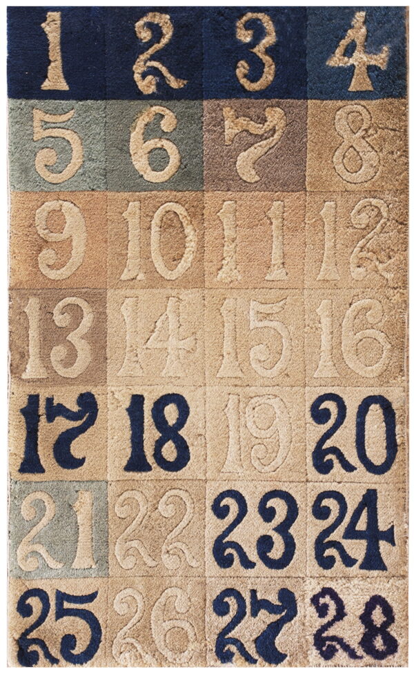 A plush, carved rug displays large numbers in alternating squares of navy, tan, brown, and green.