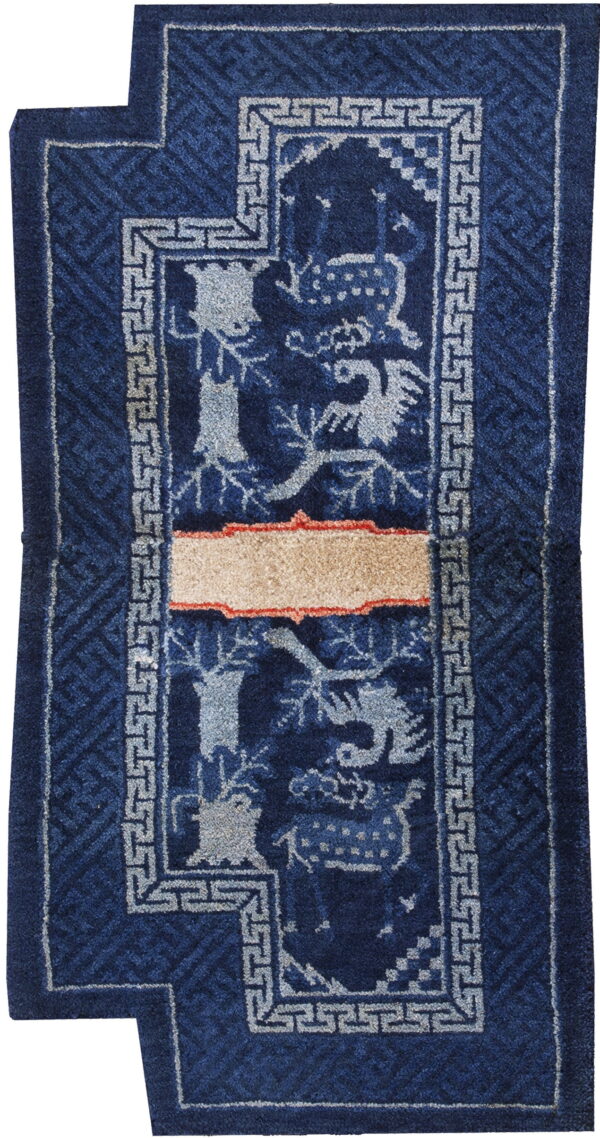 Deep blue stepped rug with light grey animal figures, greek key border, and a contrasting tan horizontal stripe.