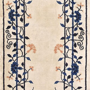 Beige runner rug with symmetrical blue and coral botanical patterns framing a wide central panel.